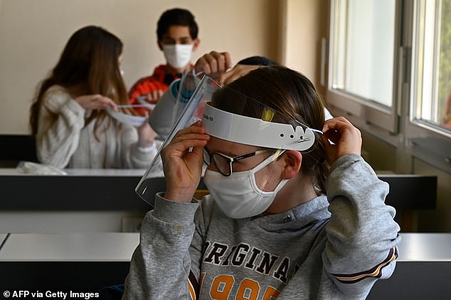 Teaching unions have urged ministers to make face masks mandatory for children in secondary schools. Pictured, a schoolchild in France