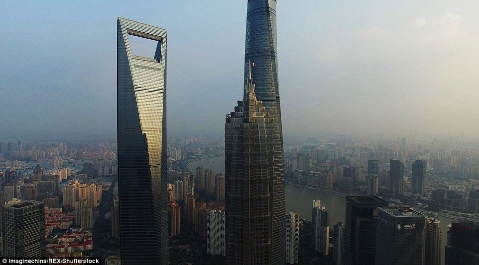 Jinmao Tower (middle) and its two neighbours: 1,621ft tall Shanghai World Financial Centre (left) and 2,073ft tall Shanghai Tower (right)