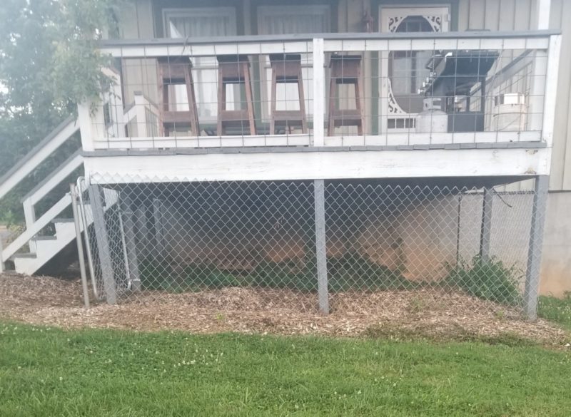 wrapping the wire around the porch for the dog kennel